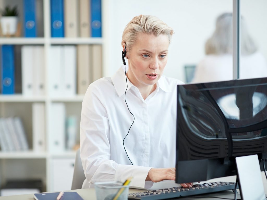 Modern Businesswoman Wearing Headset at Workplace